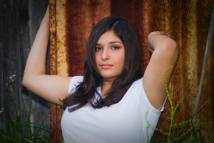 girl against tin wall